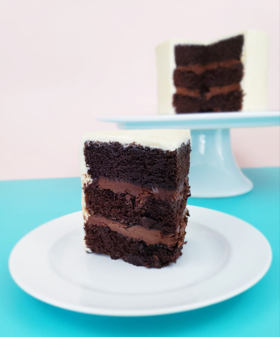 A slice of delicious, rich vegan chocolate cake from Cake Hoopla.