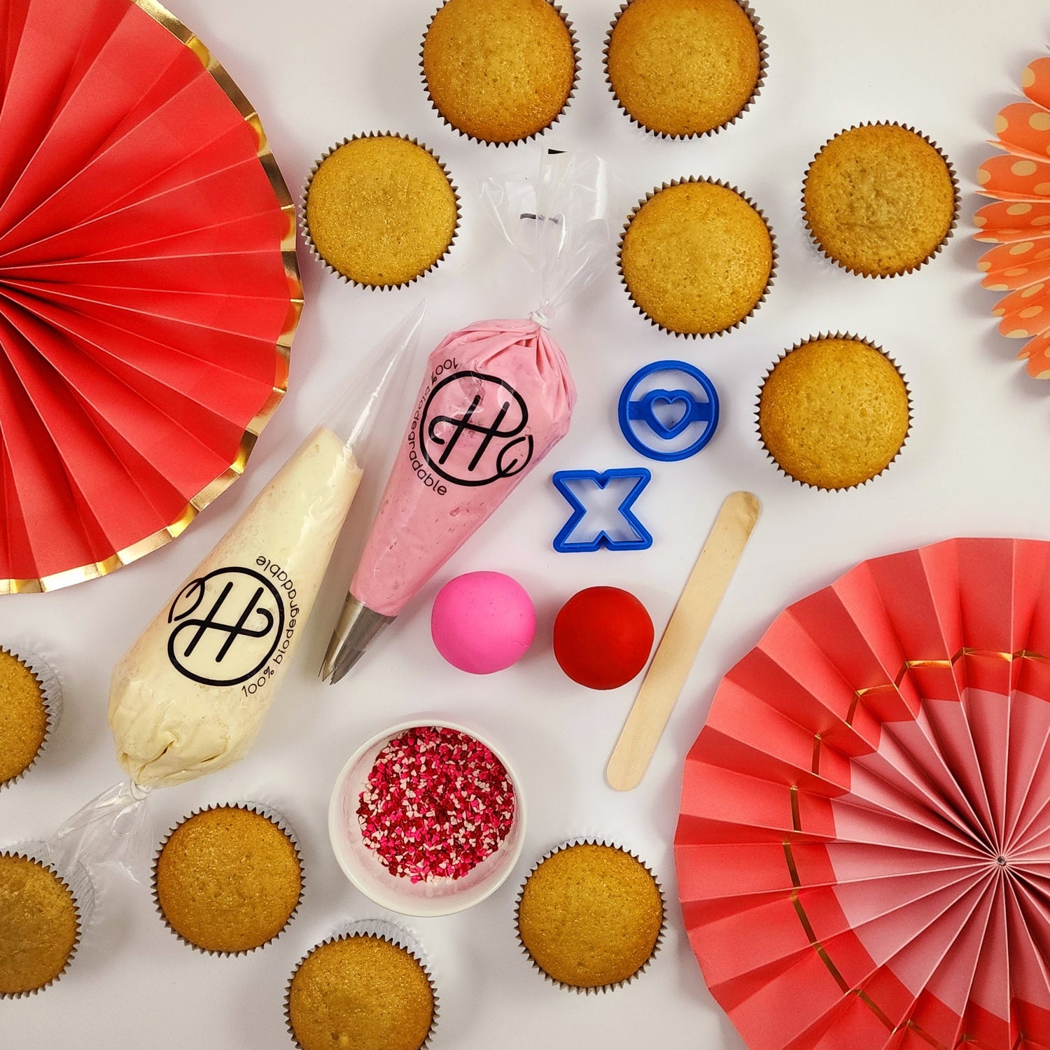 A DIY cupcake-decorating kit, including cupcakes, frosting, fondant, sprinkles, and tools.