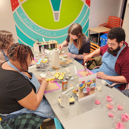 Two adult couples enjoying Valentine's Day cupcake-decorating at Cake Hoopla in Tigard, Oregon near Portland.