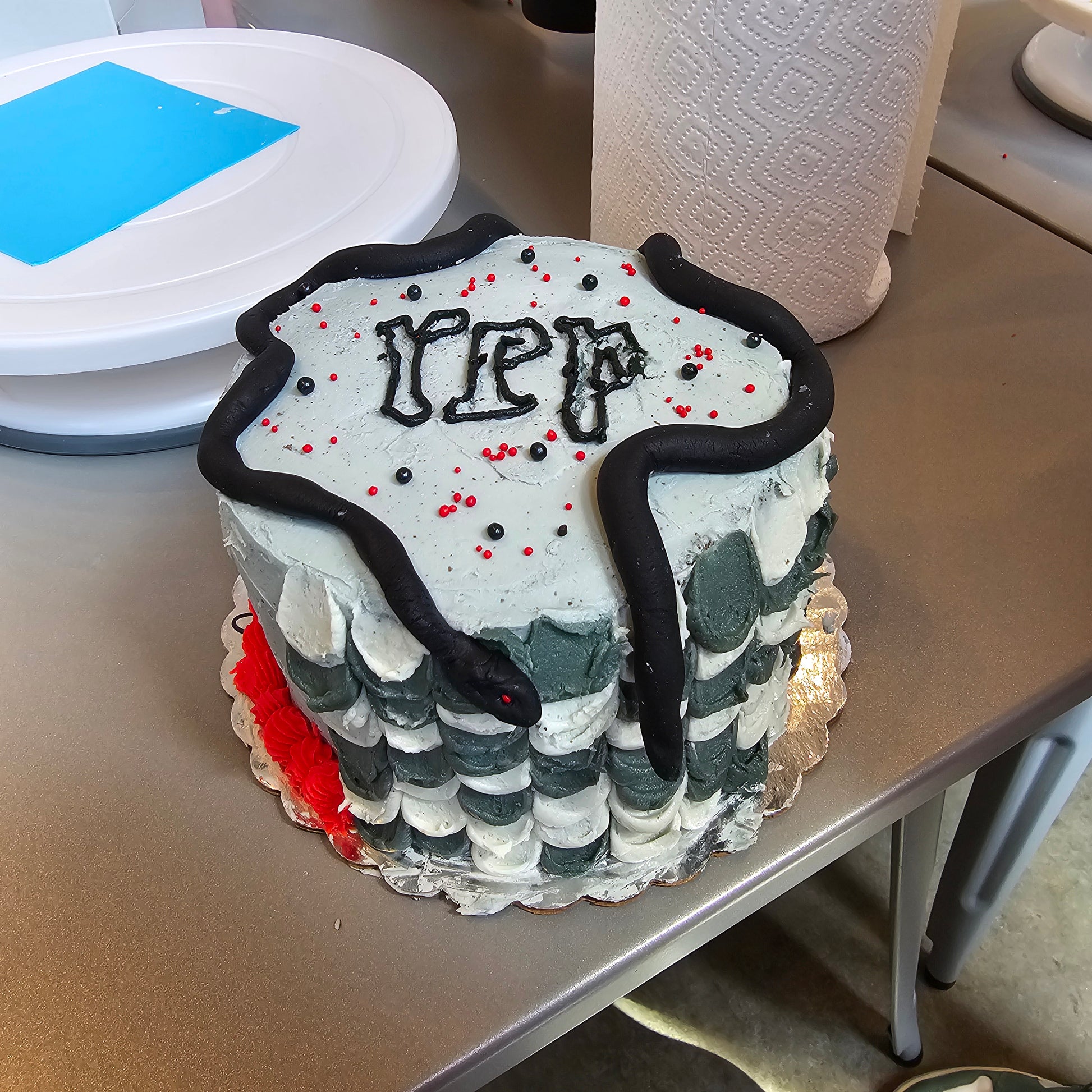 A Reputation album themed cake decorated by a kid during a Swiftie-themed cake camp at Cake Hoopla in Tigard, Oregon near Portland.