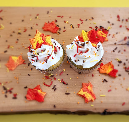 Fall-themed cupcakes with fall-colored maple leaves, orange, yellow, brown, and red sprinkles available at Cake Hoopla in the Portland area.