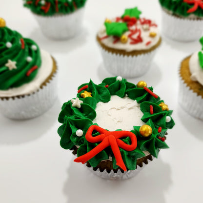 DIY cupcake decorating cupcake frosted wiht a green wreath and Christmas sprinkles as ornaments.